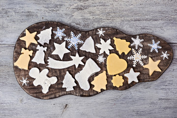 Christmas cookies on a wooden plate on a wooden background
