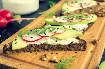 Sandwiches of rye bread with avocado and goat cheese