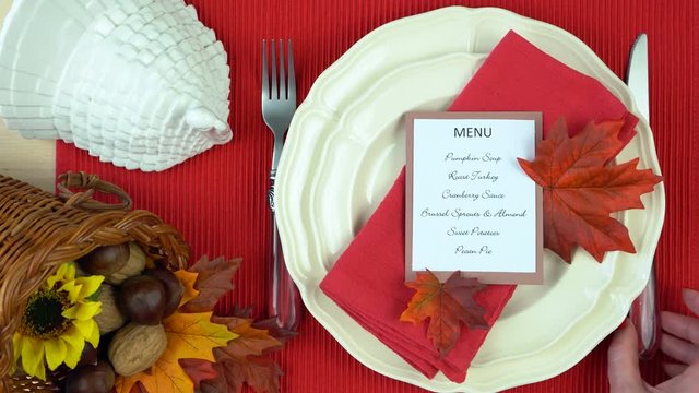 Thanksgiving place setting close up, adding final touches real time static.