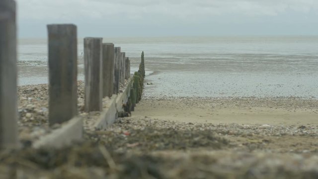 Wave breakers and shoreline on beach at low tide