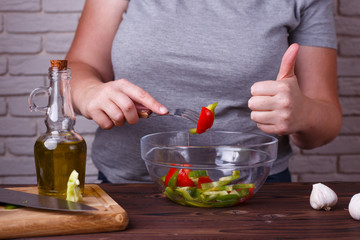 Dieting, healthy low calorie food, weight losing concept. Overweight woman eating salad and showing thumb up gesture