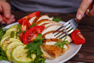 Diet concept, healthy lifestyle, low calorie food. Woman hands taking healthy balanced appetizing food from a plate.