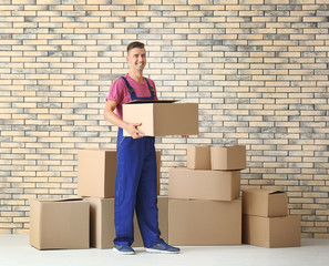 Delivery man holding box, indoors