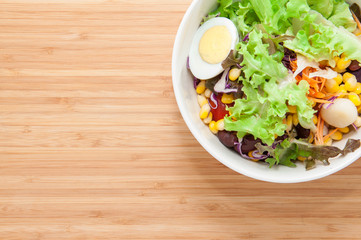 Fresh healthy salad on table.