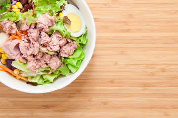 Tuna salad on wooden table.