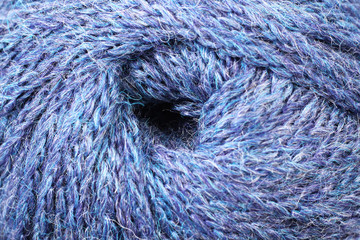 A super close up image of blue and green yarn