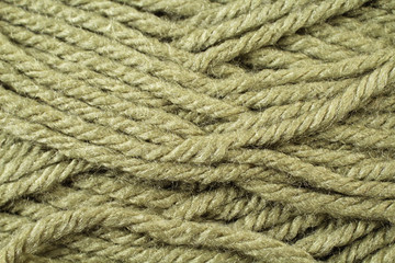 A super close up image of olive green yarn