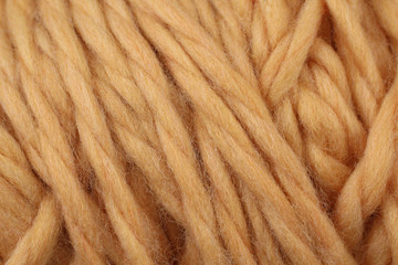 A super close up image of light orange yarn