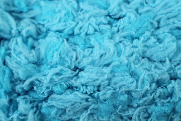 A super close up image of baby blue yarn