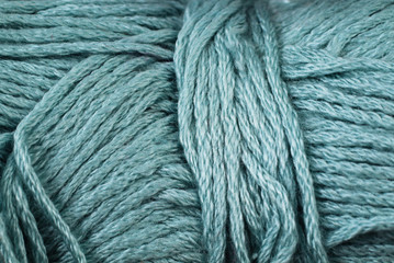 A super close up image of teal yarn