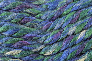 A super close up image of blue and green yarn