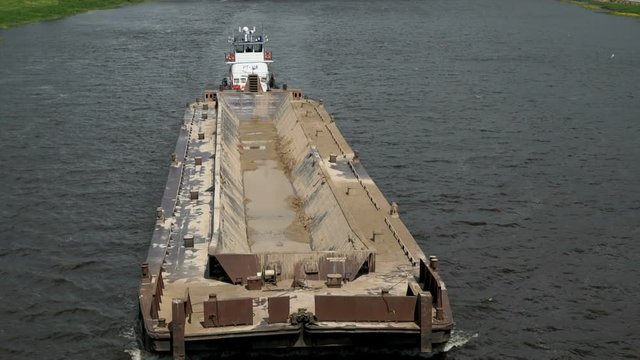 Top view of seascape - empty barge without cargo float along the river in summer sunny day