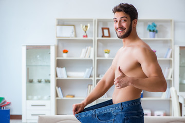 Man in oversized pants in weight loss concept