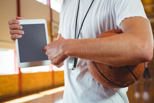 Midsection of coach showing tablet computer