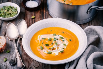 Homemade butternut squash soup with cream and seeds