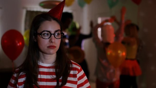  Nerdy girl at house party feeling sad & isolated while others socialize
