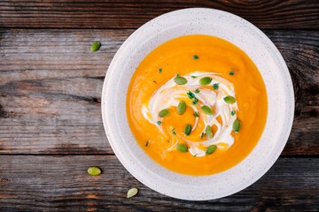 Homemade pumpkin soup with cream and seeds