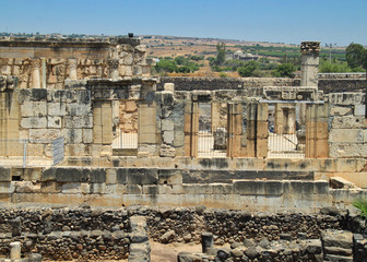 Archaeological ruins of town of Capernaum and ancient synagogue of Byzantine era with columns and bricks of basalt and