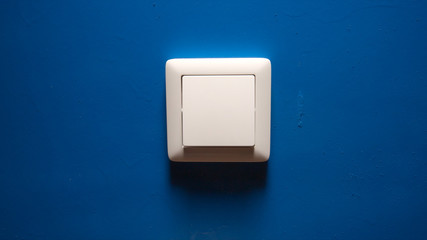 Power button on a blue wall