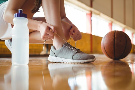 Close up of woman tying shoelace