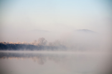 Morning on the river early morning reeds mist fog and water surface on the river