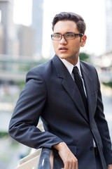 Young asian businessman working outdoors