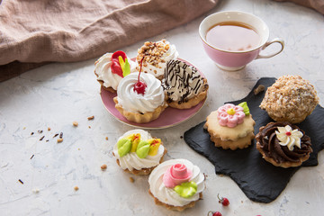 Different cakes composition on concrete background