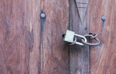 Lock key on old wooden door.