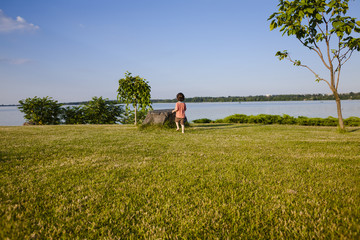 The boy runs along the grass.