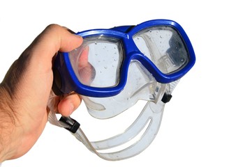 Wet diving half mask with blue frame held in adult man left hand, white background
