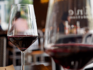Close-up macro detail of a pair of red wine glasses, with foreground blur, at an expensive Italian restaurant. Food and drinks concept. - 173869570