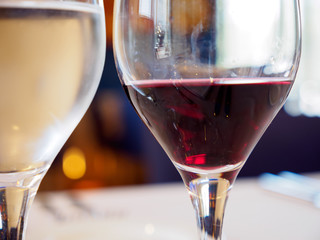 Close-up macro detail of a glass of red and white wine at a gourmet restaurant. Valencia, Spain. Food and drinks concept.