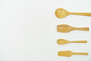 wooden spoons on white background, top view with copy space,different wooden kitchen tools