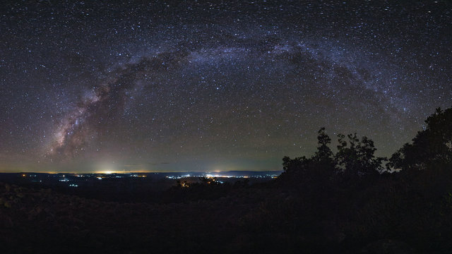 Panorama Milky way galaxy with knob stone ground is name Lan Hin Pum viewpoint at Phu Hin Rong Kla National Park in Phitsanulok, Thailand