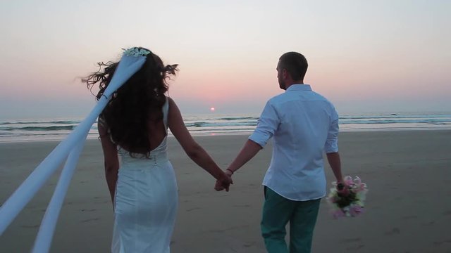 Lovers were married in India. Walk on the beach