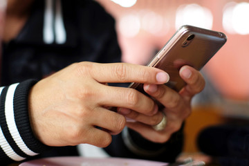 Close up male hands using a smart phone