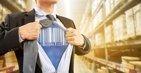 Businessman with barcode reader in warehouse, logistics