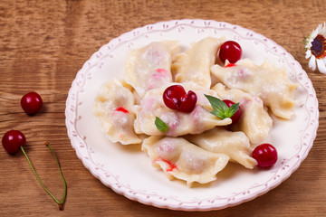 Dumplings, filled with cherries. Varenyky, vareniki, pierogi, pyrohy - popular dish in East Europe. Horizontal