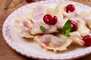 Dumplings, filled with cherries. Varenyky, vareniki, pierogi, pyrohy - popular dish in East Europe. Horizontal