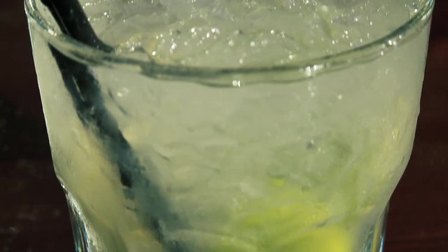 Caipiroska coktail. The camera takes the glass from the bottom up.