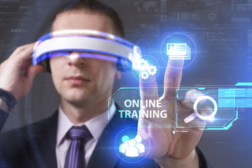 Business, Technology, Internet and network concept. Young businessman working in virtual reality glasses sees the inscription: Online training