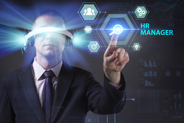 Business, Technology, Internet and network concept. Young businessman working in virtual reality glasses sees the inscription: HR manager
