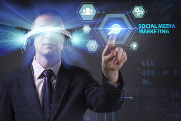 Business, Technology, Internet and network concept. Young businessman working in virtual reality glasses sees the inscription: Social media marketing