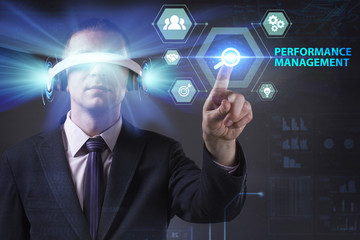 Business, Technology, Internet and network concept. Young businessman working in virtual reality glasses sees the inscription: Performance management