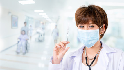 Doctor with syringe in hand in the hospotal. medical health professional holding a vaccine injection with fingers. Isolated on white background. Studio lighting. Concept for healthy