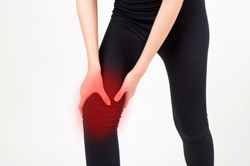 Woman with knee feeling pain. Studio shot on white background.  Fitness and health concept