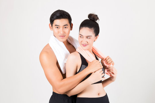 Happy young sports couple on white background .Fitness and healthy lifestyle concept. Studio shot