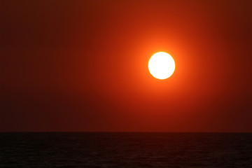 Fototapeta na wymiar A fiery sunset over the Sea