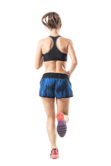 Rear view of fit athletic female sprinter running movement. Full body length portrait isolated on white studio background.