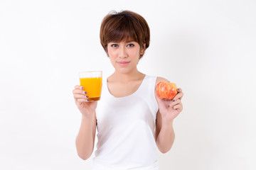 Beautifulyoung Asia woman with healthy food. Isolated on white background. Studio lighting. Concept for healthy.